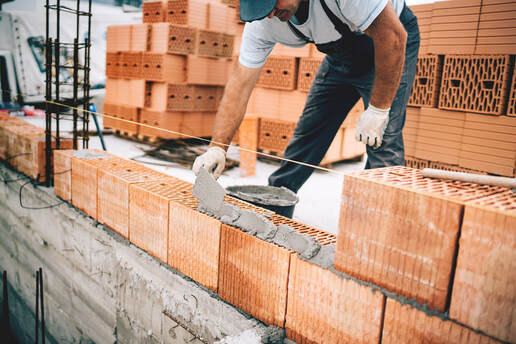 man installing concrete bricks